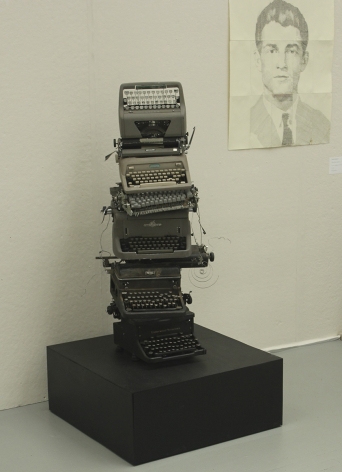 SCARLETT McCALMAN Stack #1 2014, stacked typewriters and gravity on pedestal, 30 x 30 x 15 inches.